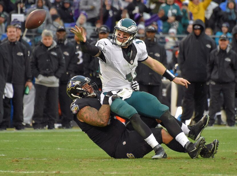 Baltimore Ravens defensive end Lawrence Guy drags down Philadelphia Eagles quarterback...