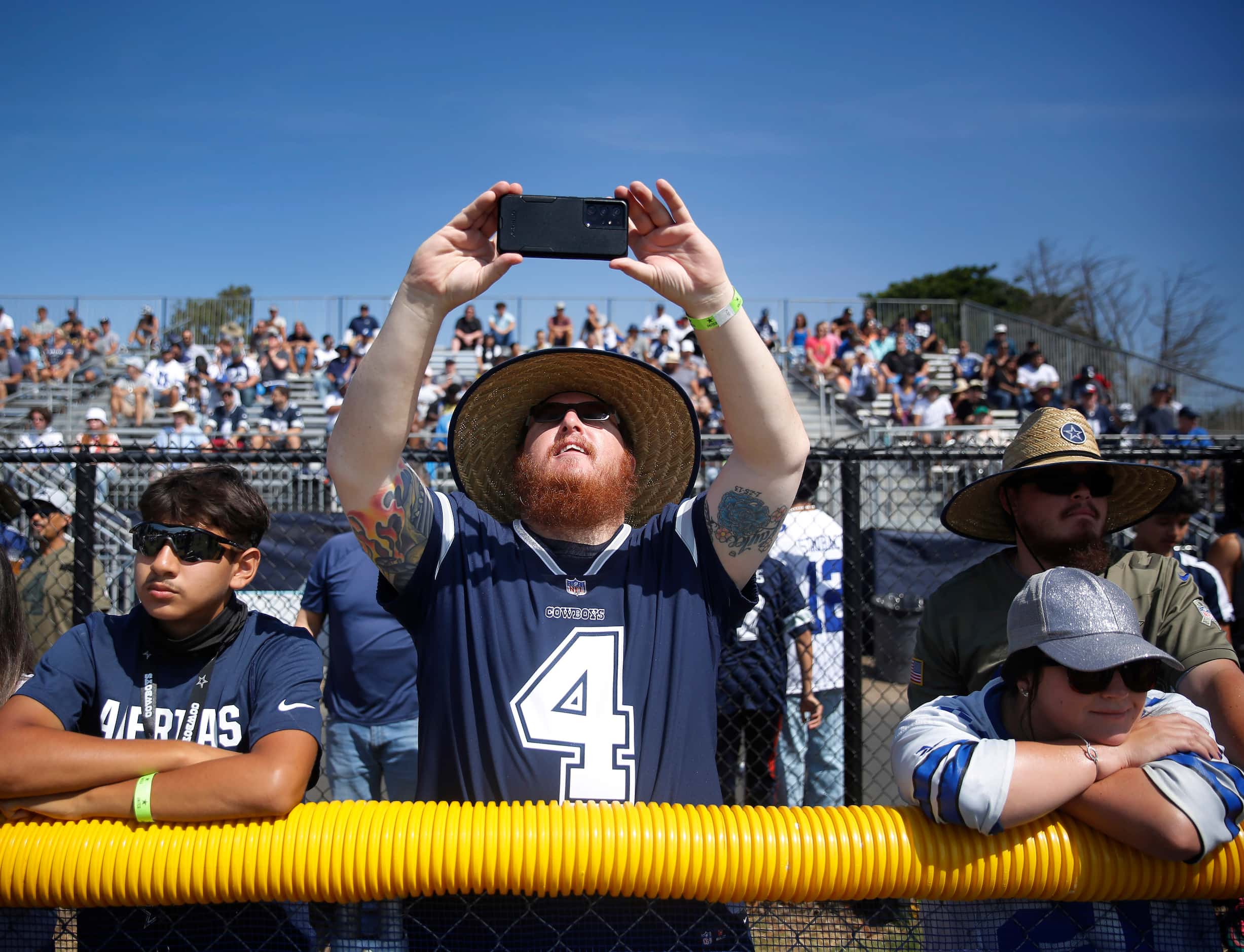 Dallas Cowboys fan Wage Jones of Montclair, California records players participating in a...