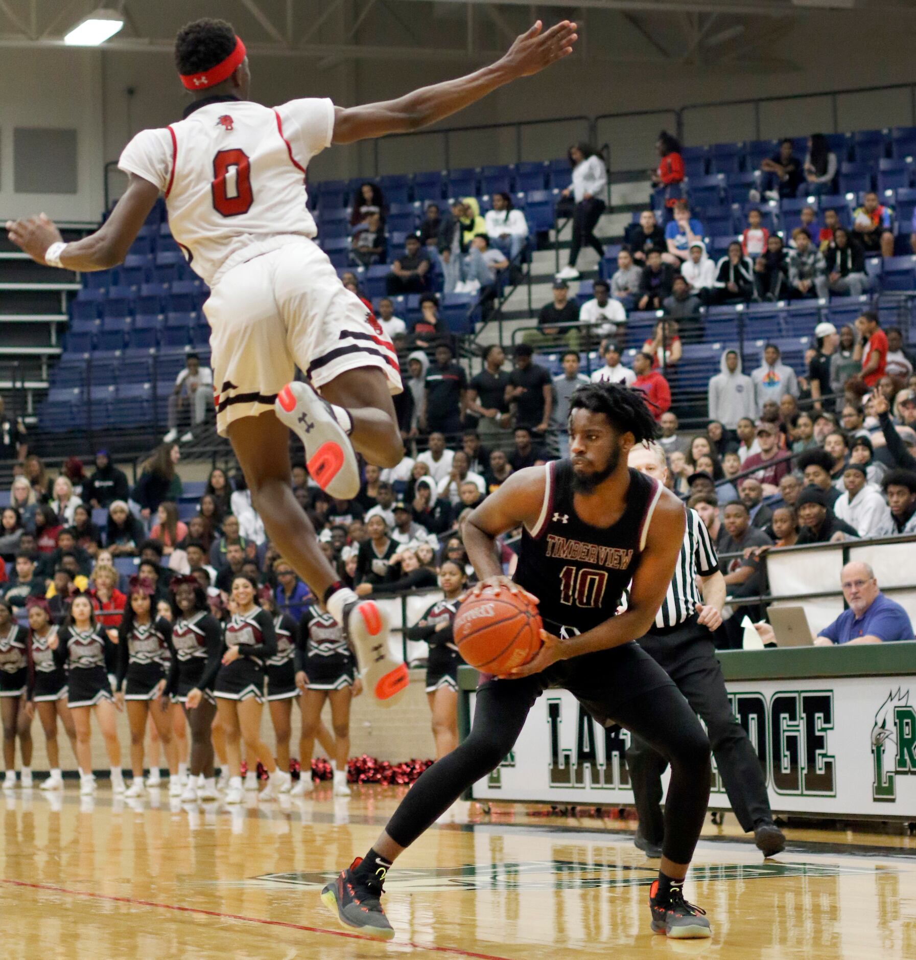 Mansfield Timberview senior guard Ahmad Richardson (10) pulls back as he fakes a jump shot...