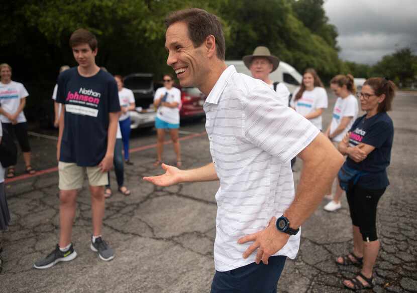 Nathan Johnson talks with volunteers before they set out to canvass a neighborhood during...