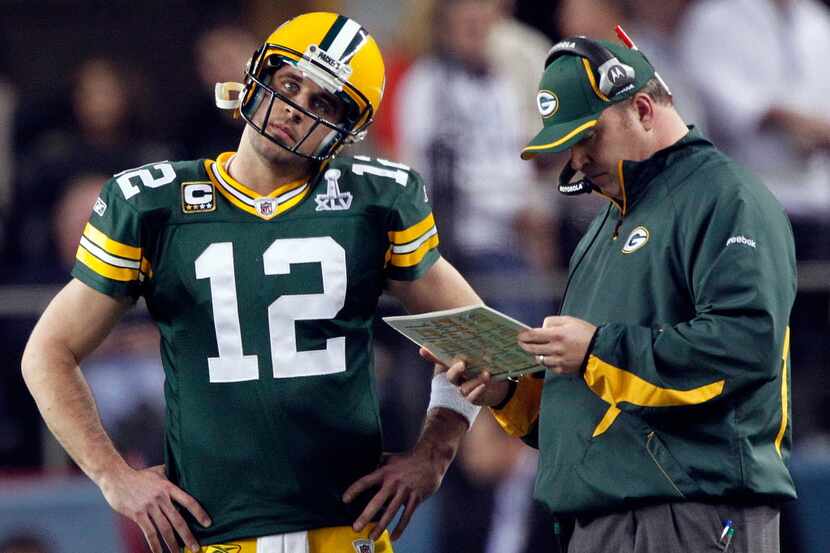Green Bay Packers quarterback Aaron Rodgers listens to head coach Mike McCarthy in Super...