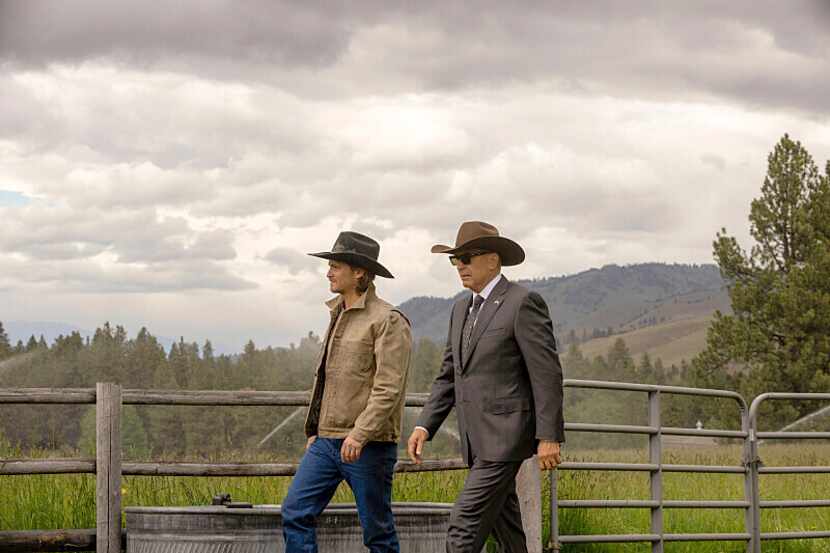 Luke Grimes, left, and Kevin Costner appear in a scene from "Yellowstone." The popular...