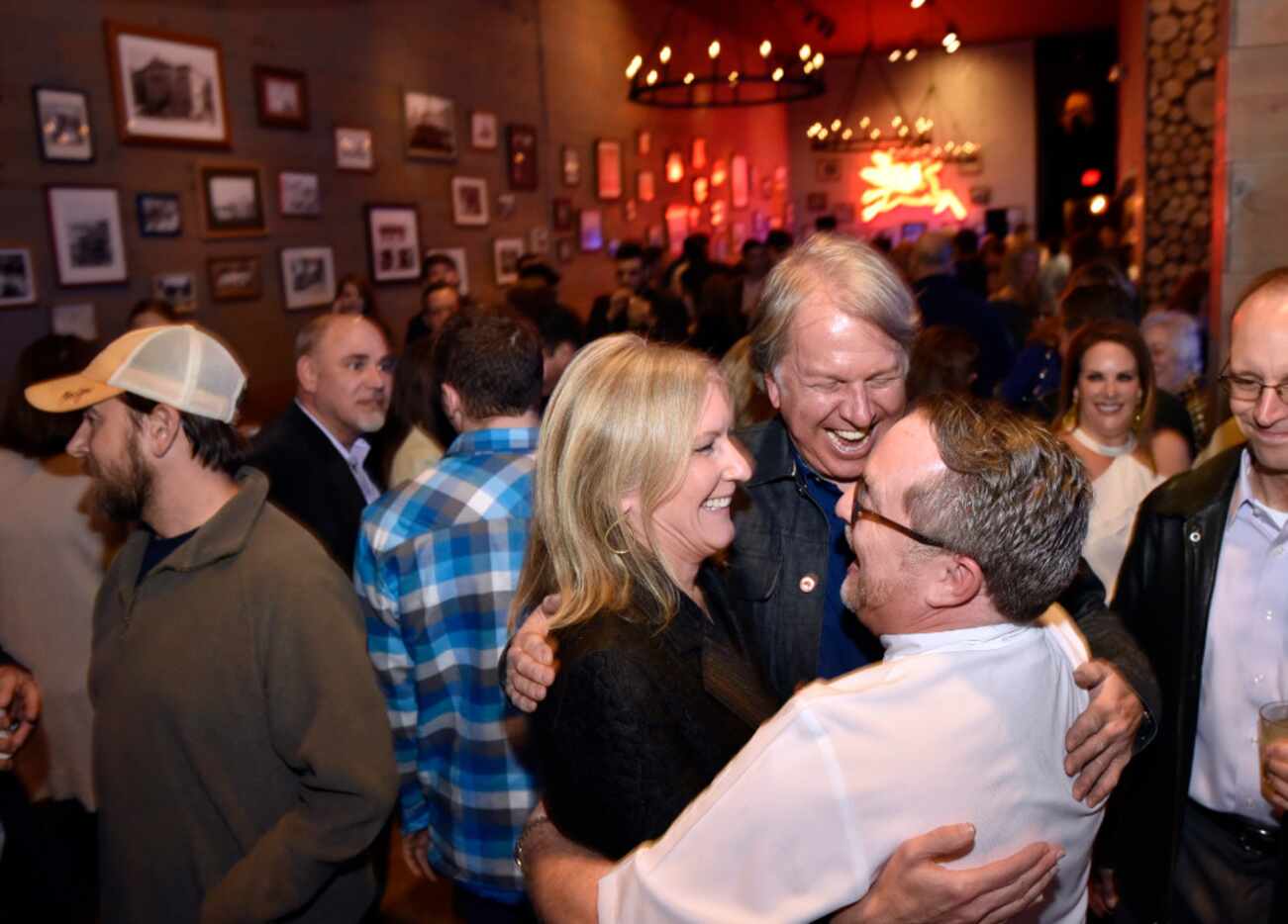 Wanda Gierhart, left, Chef Dean Fearing, hug Jeffrey Kollinger, right, owner of Tillman's...