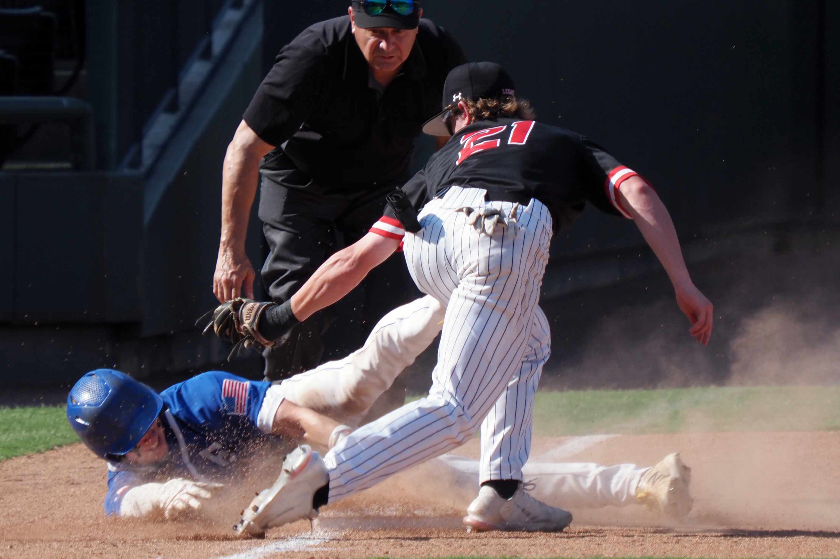 Mansfield Legacy third baseman Luke Devasher (21) tags Friendswood baserunner Ty Brantley...