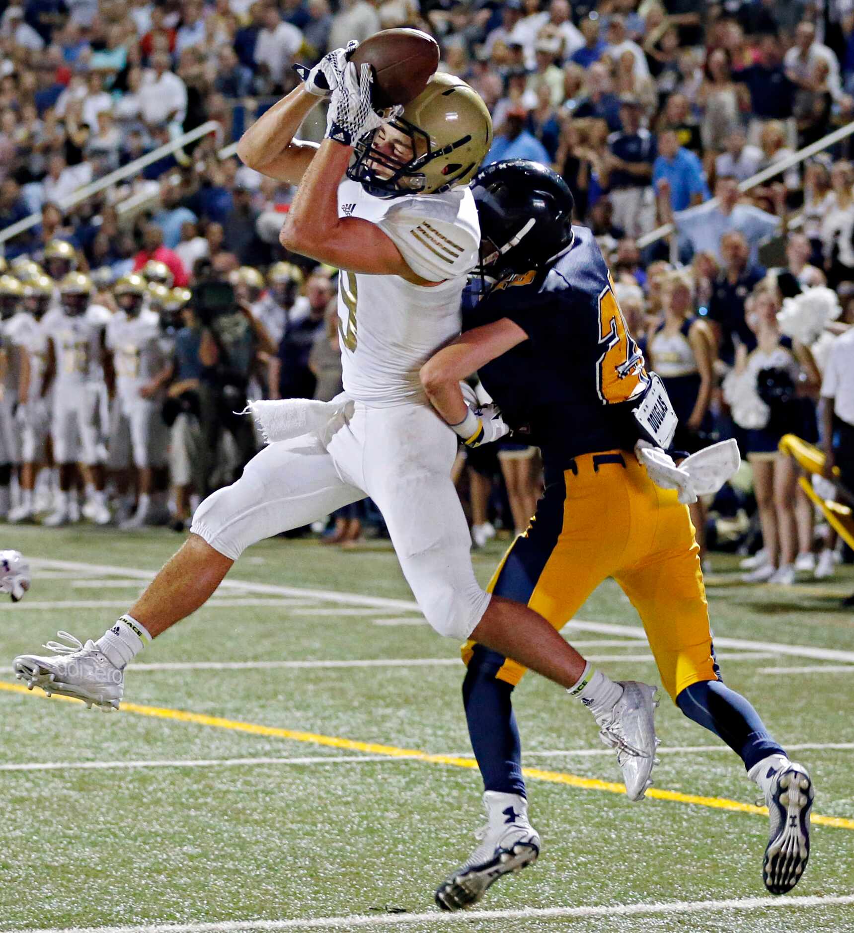 Pulaski's Justin Charette (left) comes up with a touchdown pass under pressure from Highland...