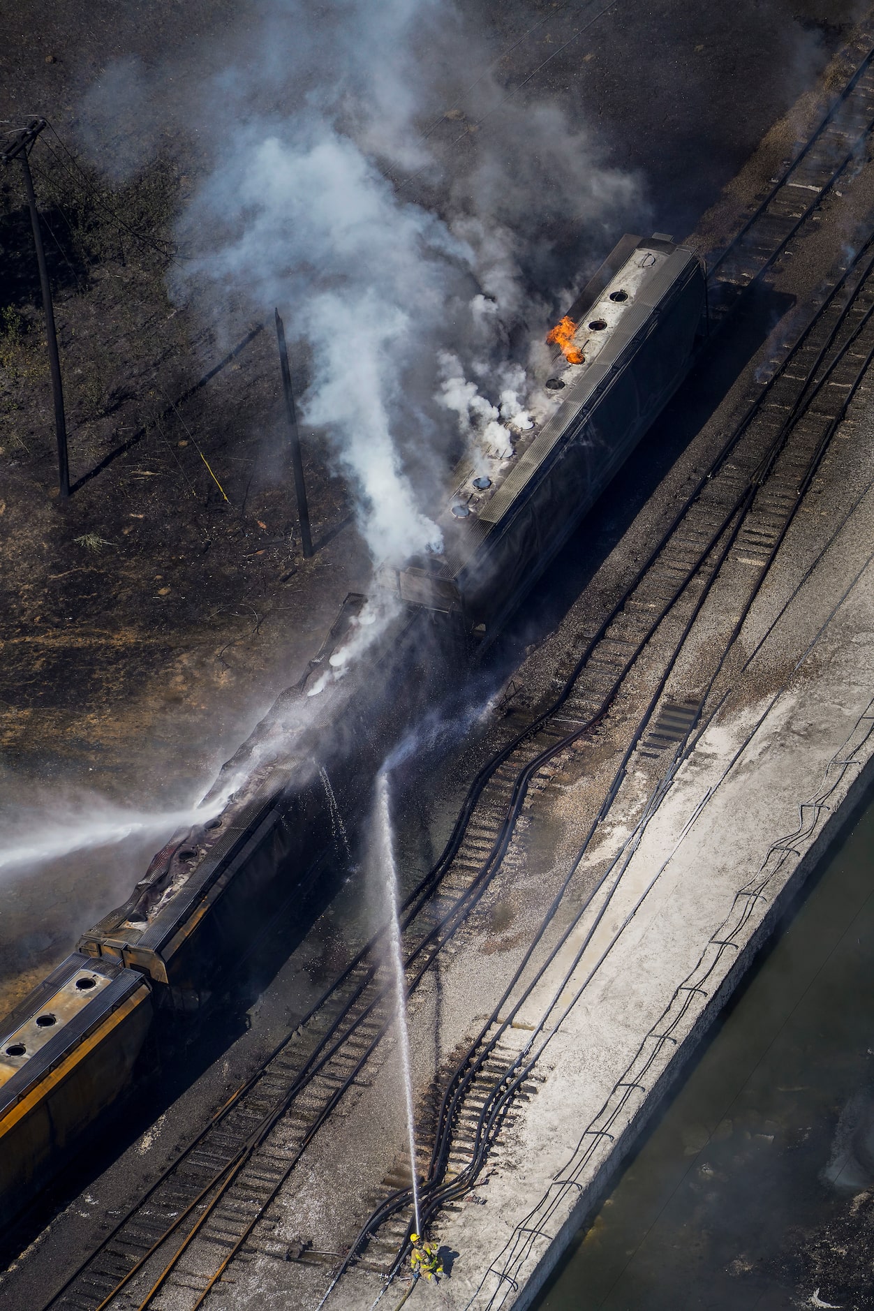 Aerial view of fire crews working at the site of a massive blaze in an industrial area on...