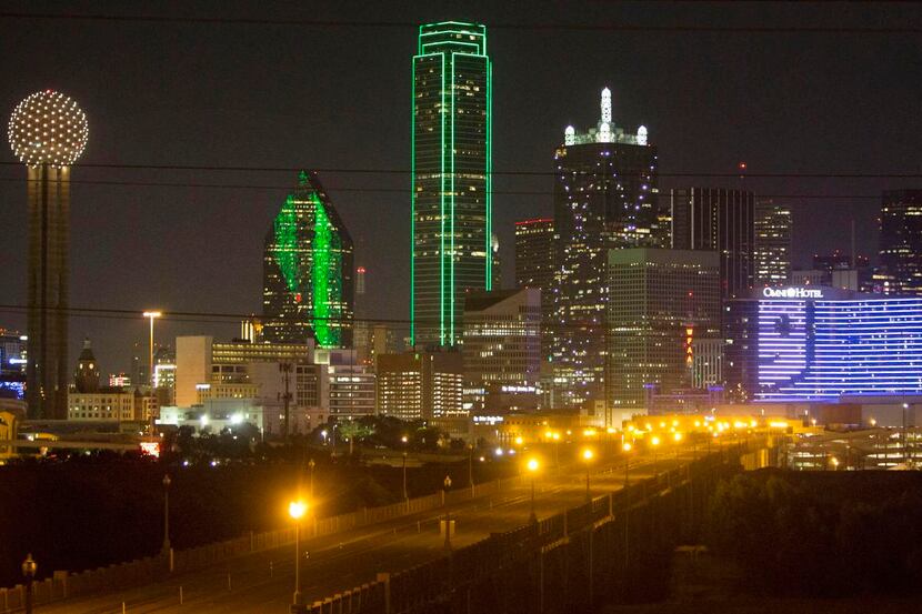 
Dallas’ Omni hotel dominates the south side of the skyline at night. It displayed the...