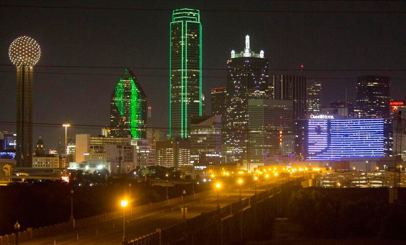 
Dallas’ Omni hotel dominates the south side of the skyline at night. It displayed the...
