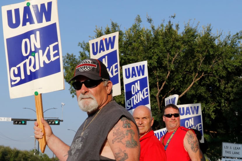 Retired GM worker Jeff Adler, left, came out to picket with other General Motors Assembly...