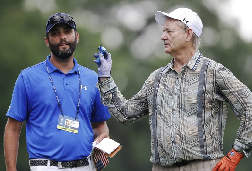 Entertainer Bill Murray fans Michael Greller on the fourth hole during the Colonial Pro-Am...