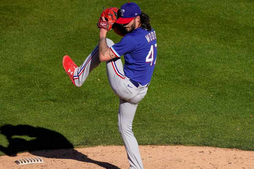 Texas Rangers pitcher Hunter Wood delivers during the ninth inning of a spring training game...