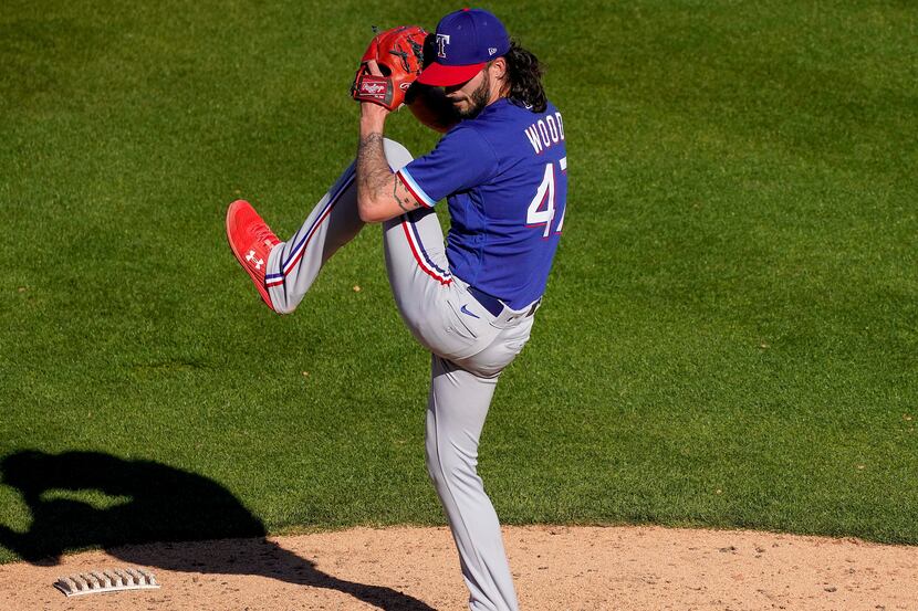 Texas Rangers pitcher Hunter Wood delivers during the ninth inning of a spring training game...