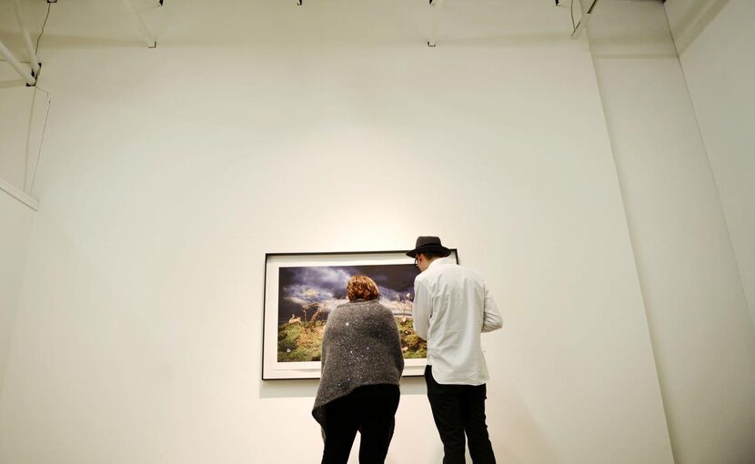 
Diana Pollak and Jason Acton look at a photograph by Shawn Saumell at the Cohn Drennan...