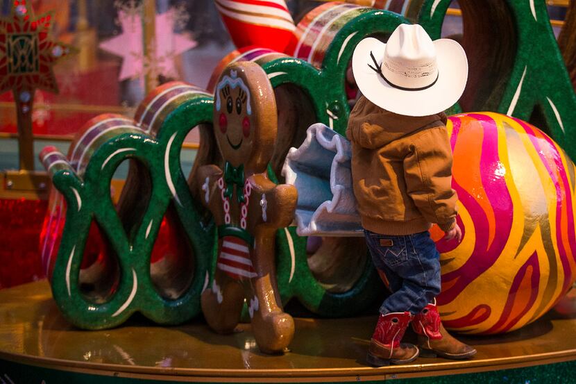 A youngster climbed on decorations in Sundance Square before the XTO Energy 2016 Parade of...