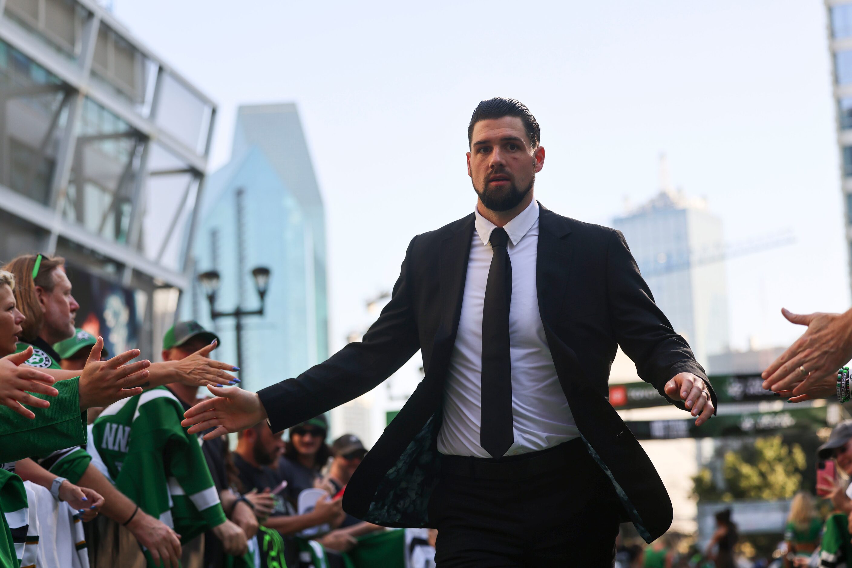 Dallas Stars left wing Jamie Benn high fives fans as he makes his way during the team’s home...