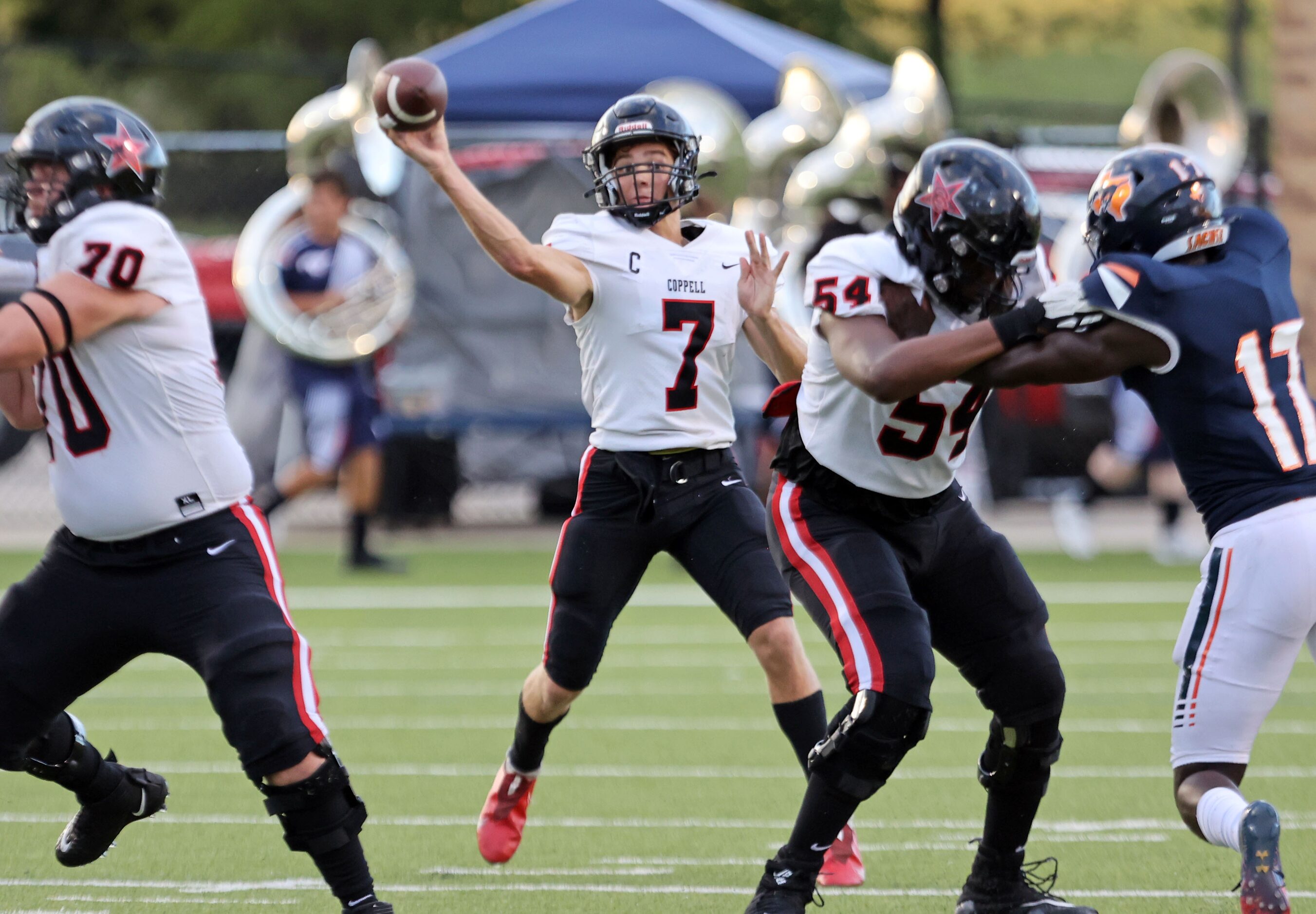 Coppell QB Jack Fishpaw (7) looks for a receiver during the first half of a high school...