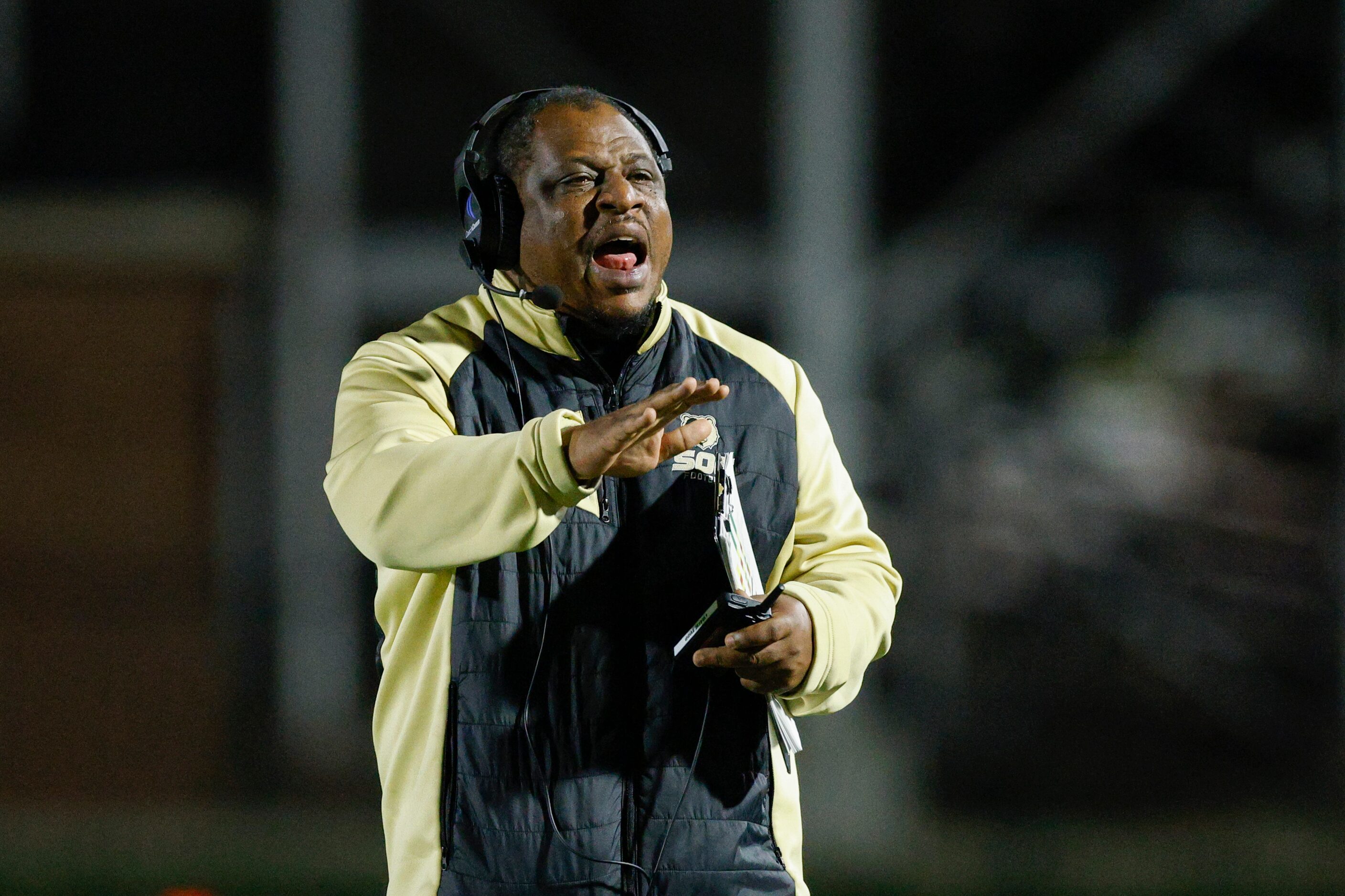 South Oak Cliff head coach Jason Todd talks to his team during the second half of a game...