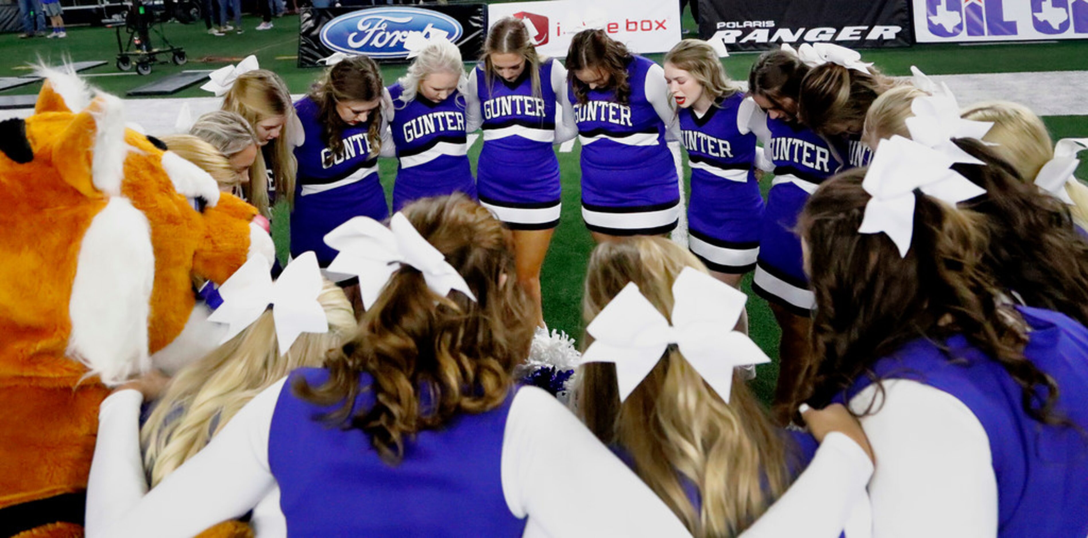 The Gunter High School cheerleaders huddle before kickoff  as Omaha Pewitt High School...