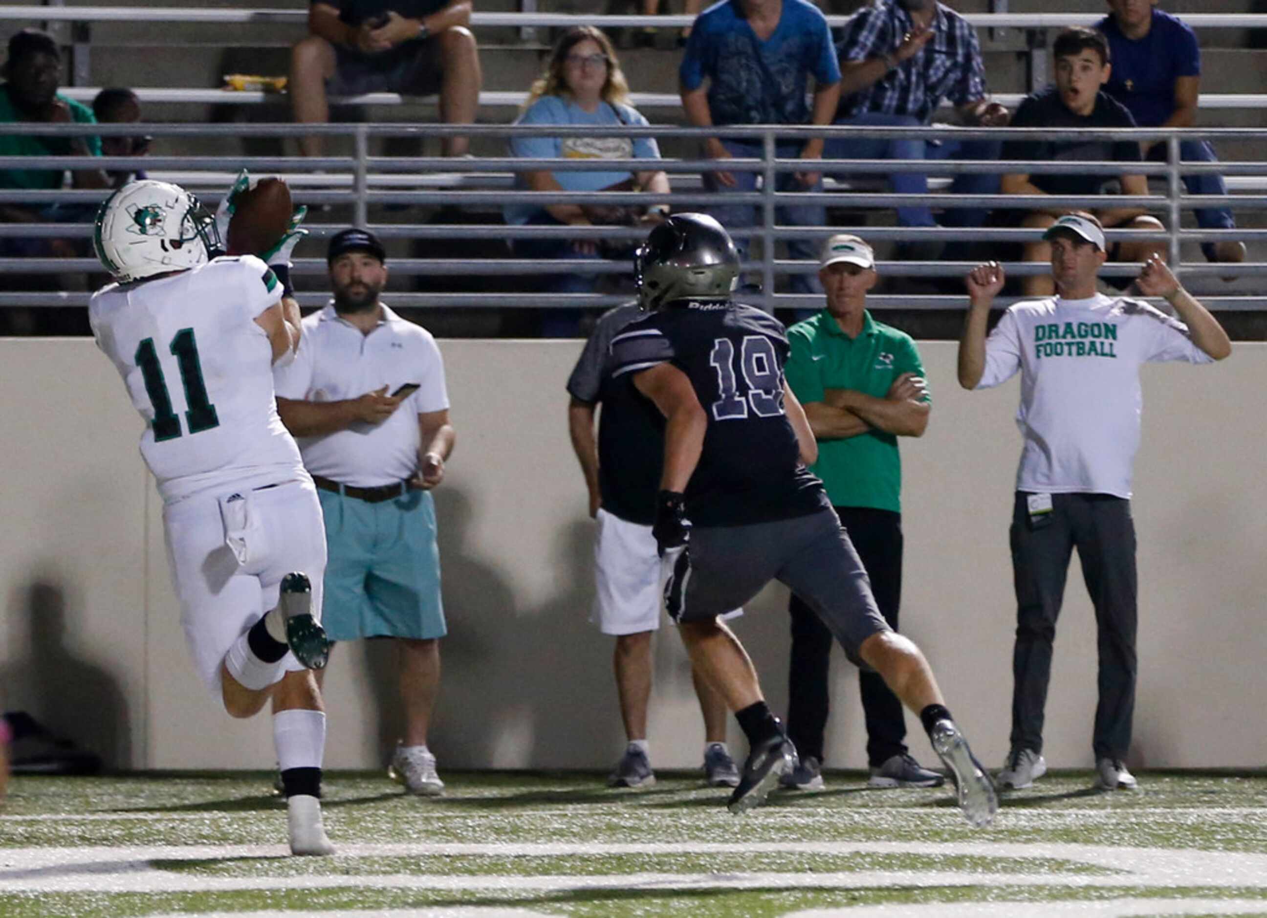 Southlake Carroll's Blake Smith (11) prepares to catch a touchdown in front of Denton...