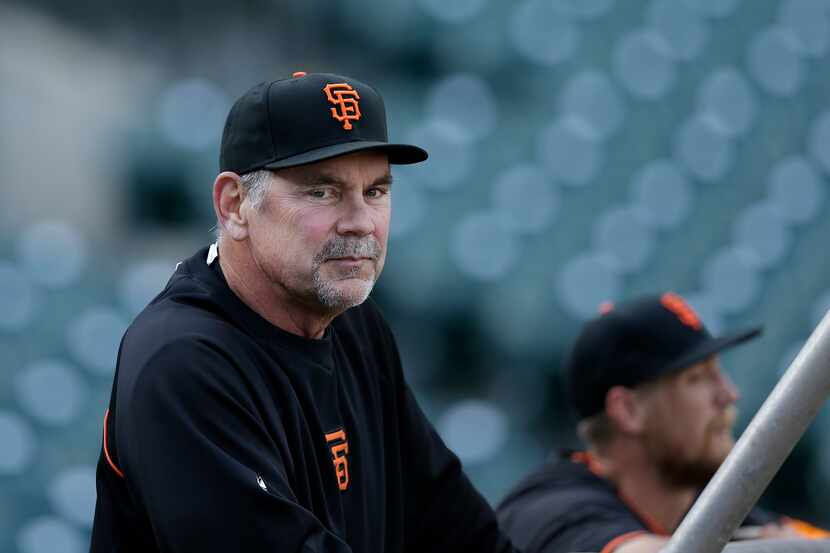 San Francisco Giants manager Bruce Bochy watches batting practice before an exhibition...