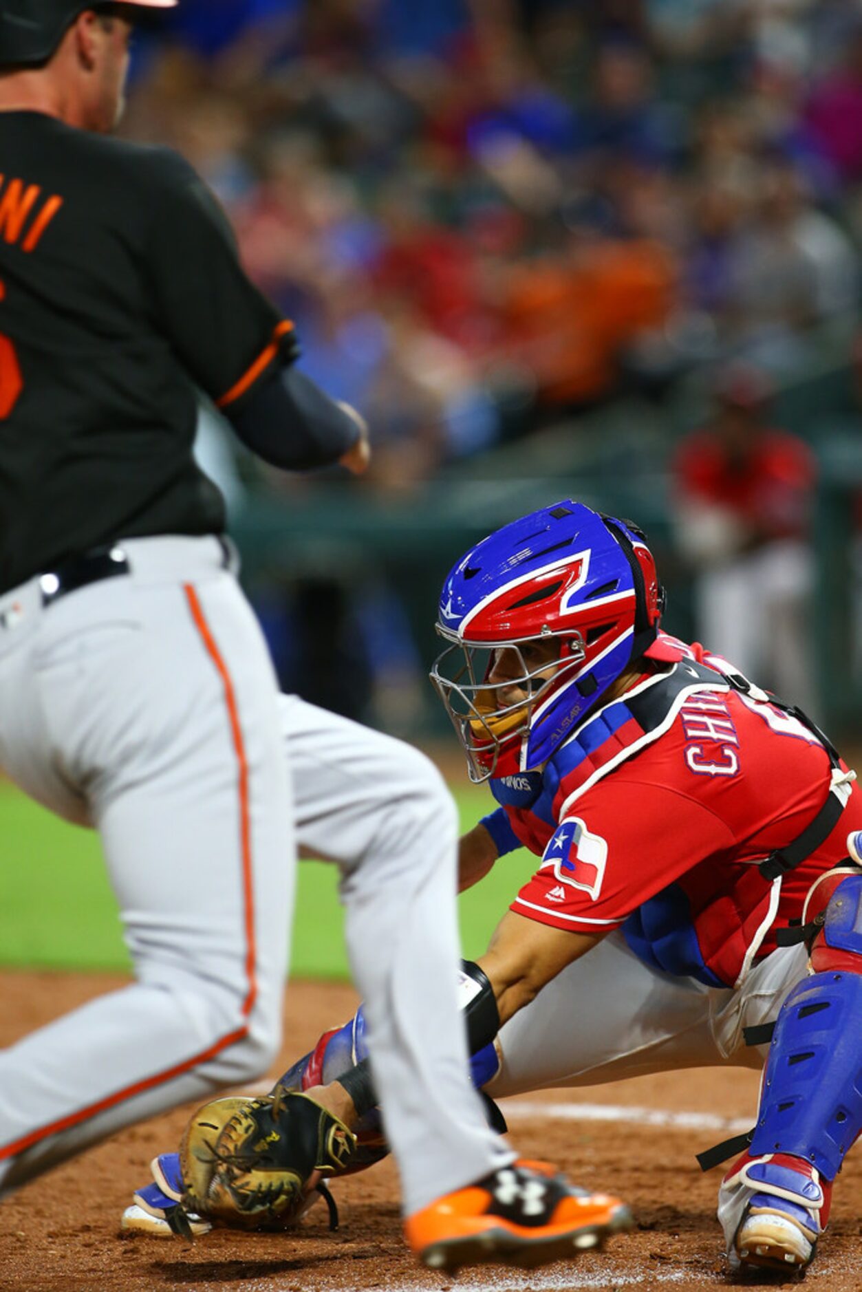 ARLINGTON, TX - AUGUST 03: Robinson Chirinos #61 of the Texas Rangers tags out Trey Mancini...