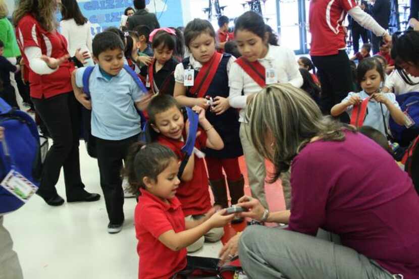 
F.M. Gilbert Elementary principal Patty Gustamante looks through a donated backpack along...