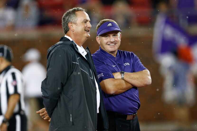 TCU coach Gary Patterson, right, and SMU coach Sonny Dykes, left, talk before an NCAA...