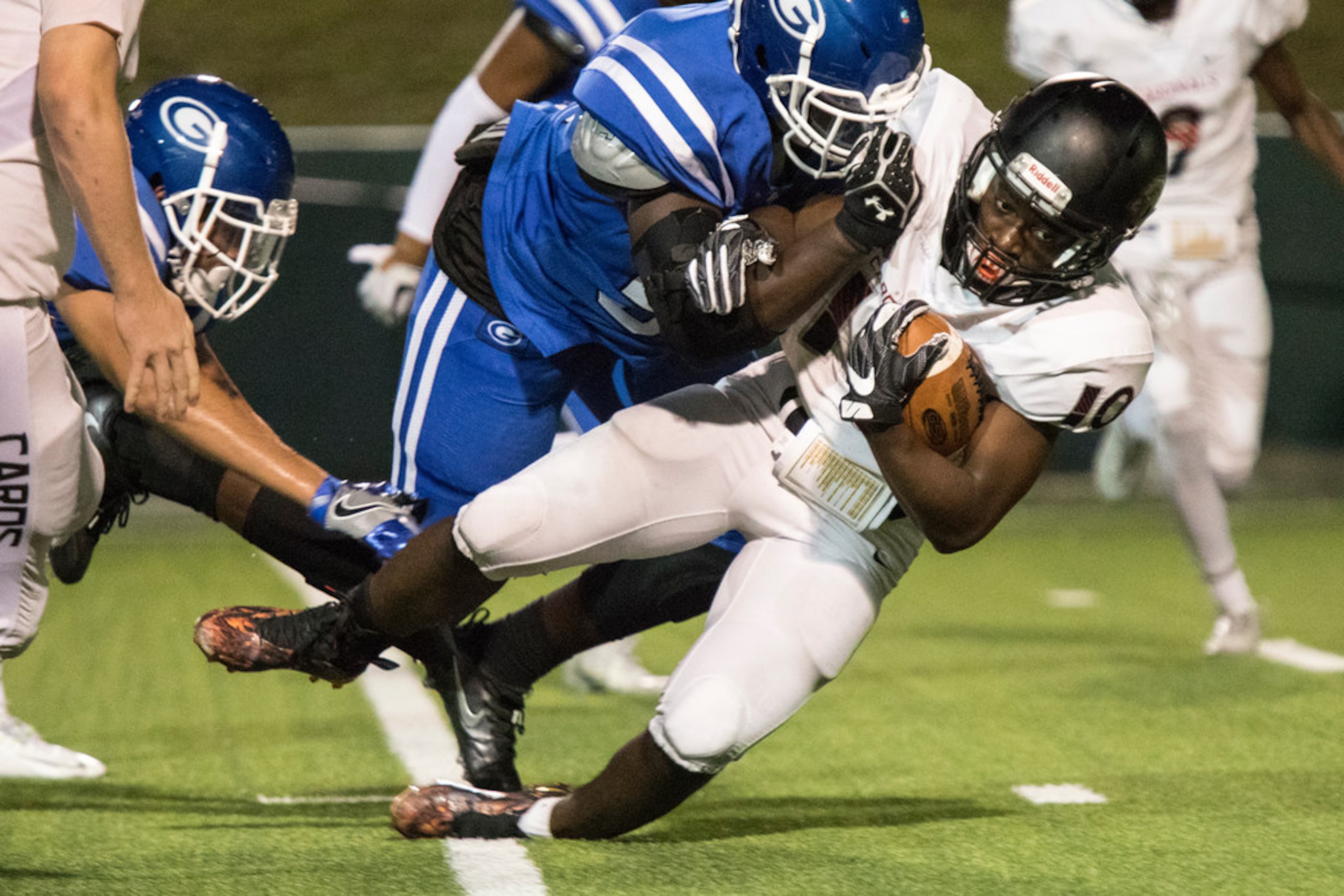 Irving MacArthur wide receiver Joseph Nuamah (10) pushes for extra yards during a District...