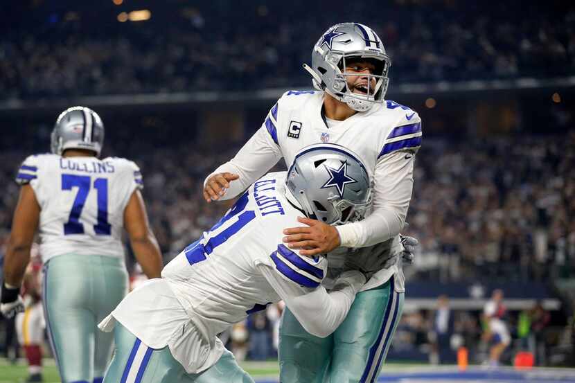 FILE - Cowboys quarterback Dak Prescott (4) celebrates with running back Ezekiel Elliott...