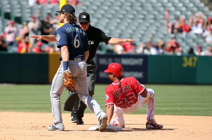 Umpire Ron Kulpa signals 'safe' as Los Angeles Angels Ben Revere takes second on an RBI...