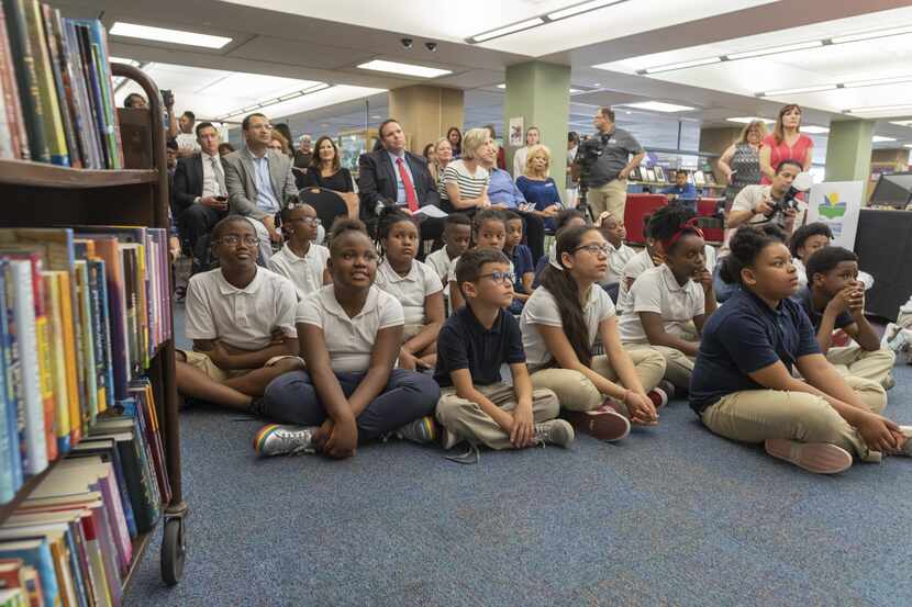Un grupo de niños escucha al alcalde Mike Rawling presentar el desafío de lectura para el...