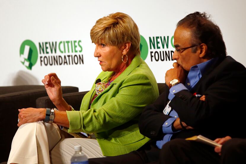 Betsy Price (left), mayor of Fort Worth, takes part in a panel as Anil Menon listens during...
