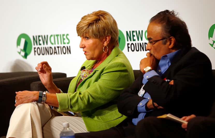 Betsy Price (left), mayor of Fort Worth, takes part in a panel as Anil Menon listens during...