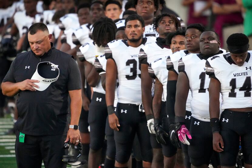 Mansfield Timberview head coach James Brown stands his his players for a moment of silence...