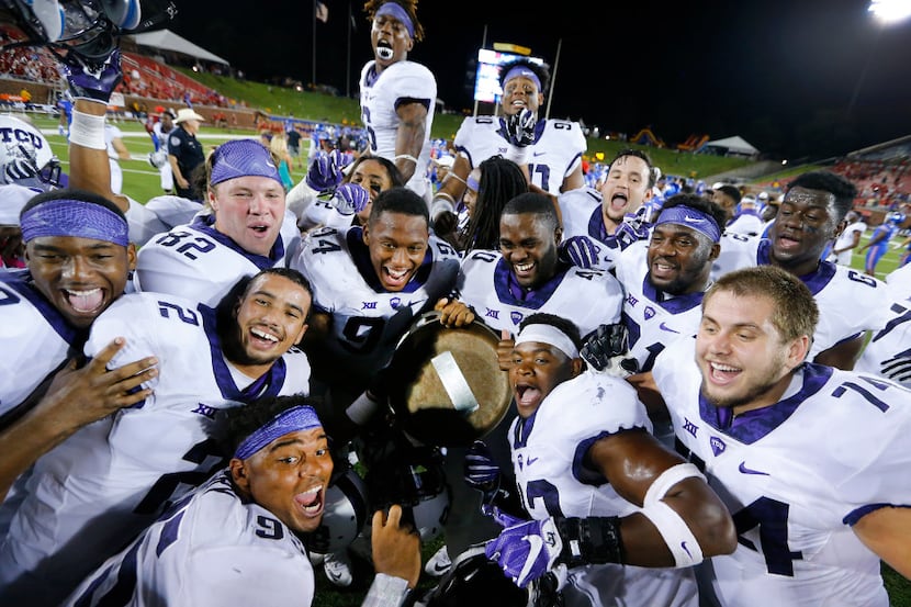 TCU Horned Frogs football players try to get into a group photo as they show off the Iron...
