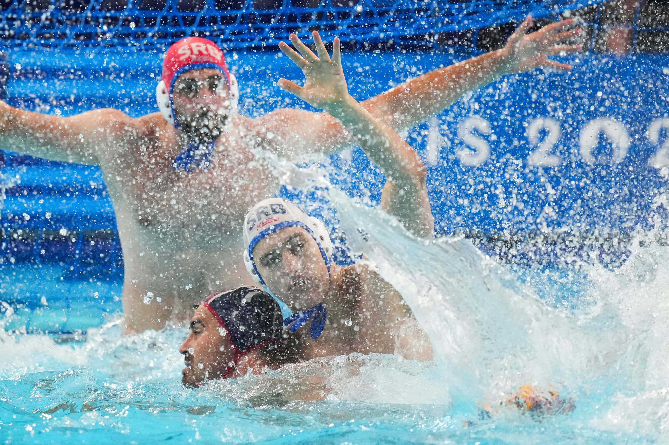 Ben Hallock (left) of the United States gets tangled with Radomir Drasovic of Serbia during...