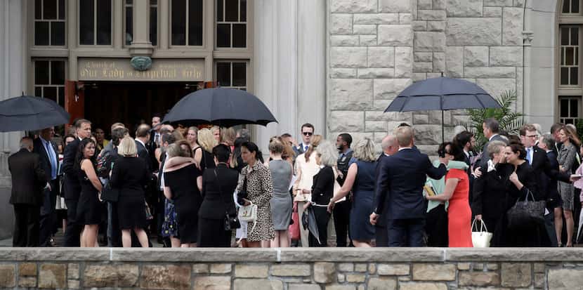 Mourners for Kate Spade gather outside Our Lady of Perpetual Help Catholic Church in Kansas...