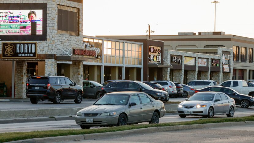 Cars pass Royal Korea Town Plaza along Royal Lane in Dallas. The Korean Chamber of Commerce...