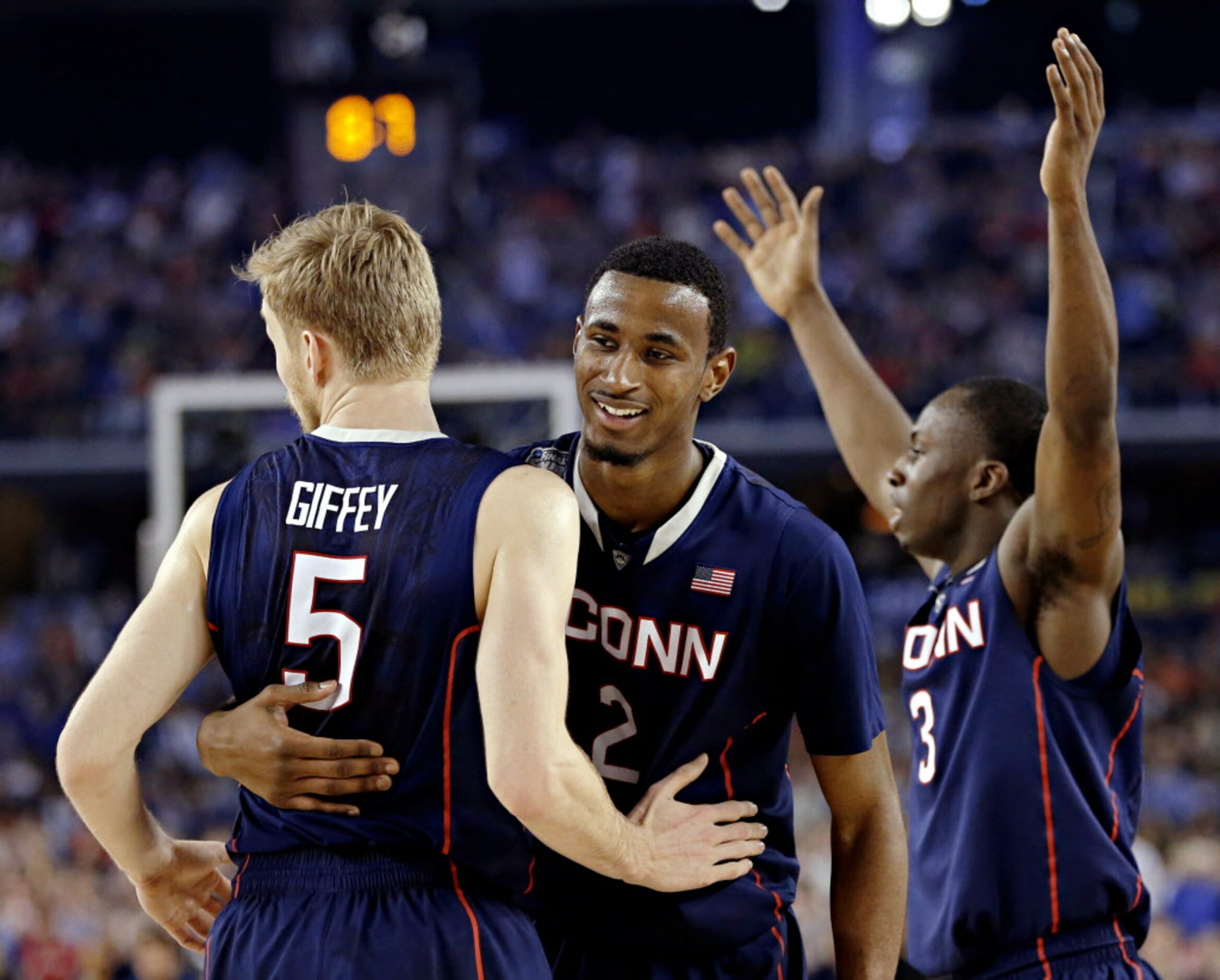 (From left) Connecticut Huskies guard/forward Niels Giffey, forward DeAndre Daniels and...