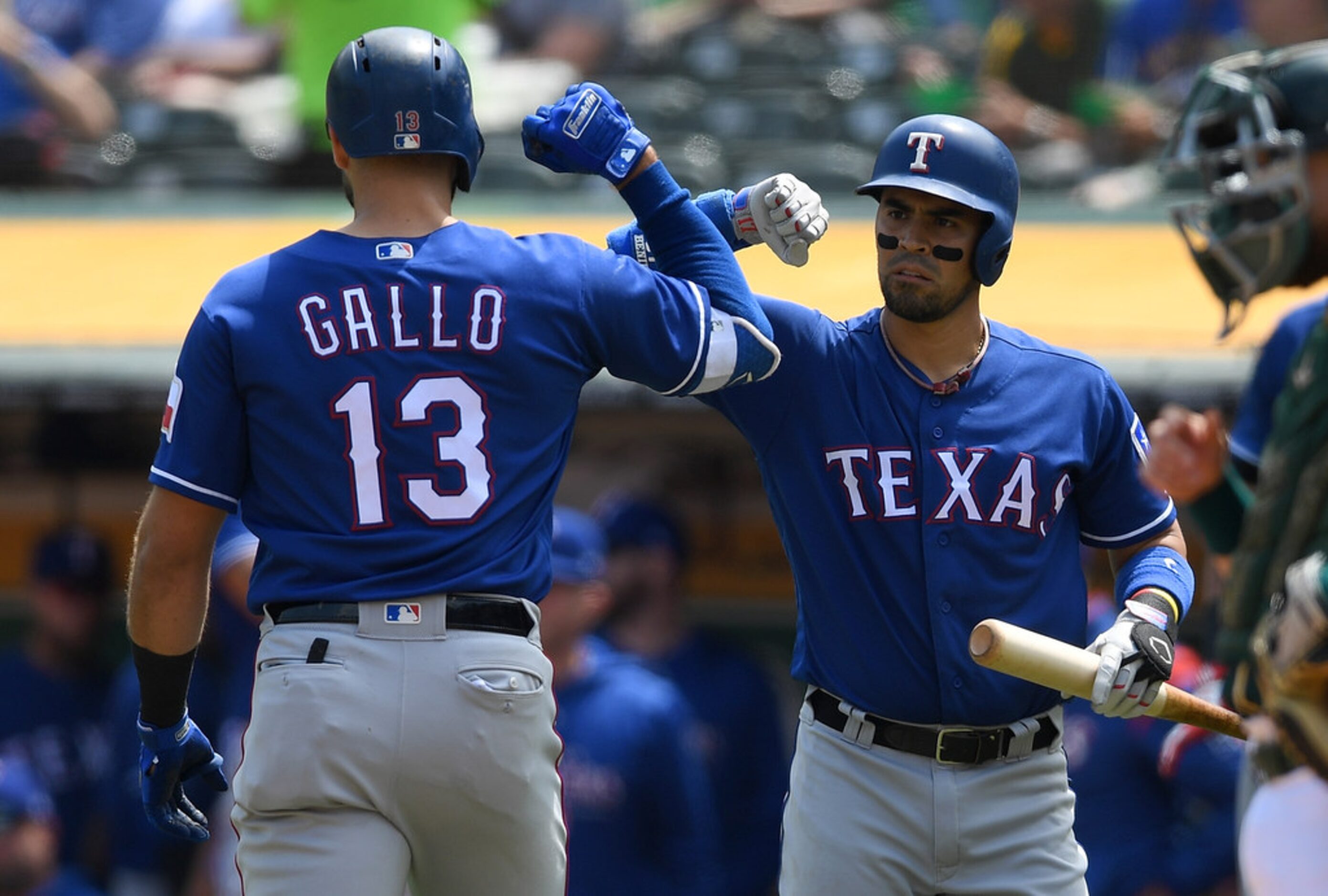 OAKLAND, CA - AUGUST 22:  Joey Gallo #13 of the Texas Rangers is congratulated by Robinson...