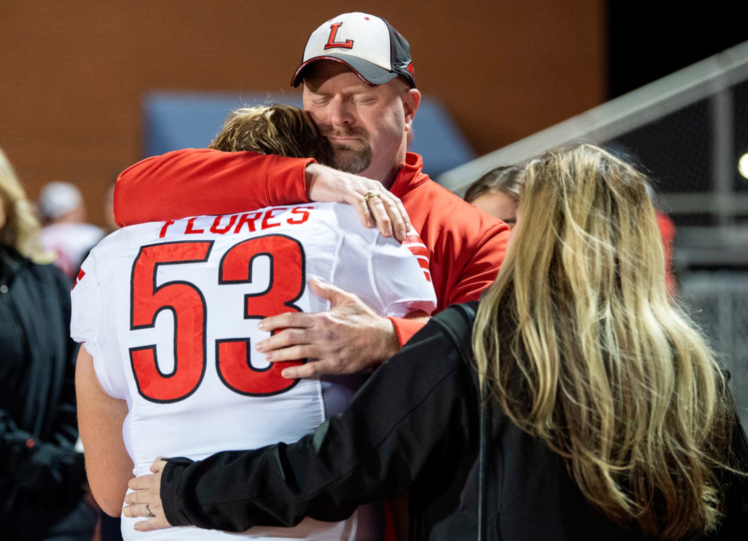 Mansfield Legacy's Ty Flores (53) is consoled by his father Wes Flores and mother Michelle...