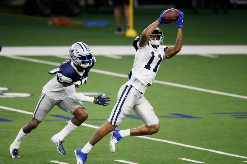 Dallas Cowboys wide receiver Cedrick Wilson (11) catches a pass in front of Dallas Cowboys...