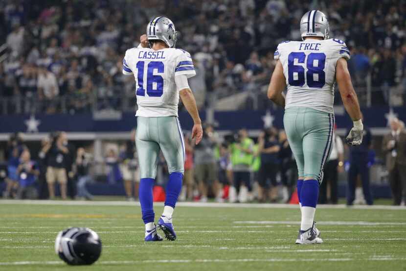 Dallas Cowboys quarterback Matt Cassel (16) and tackle Doug Free (68) walk off the field...