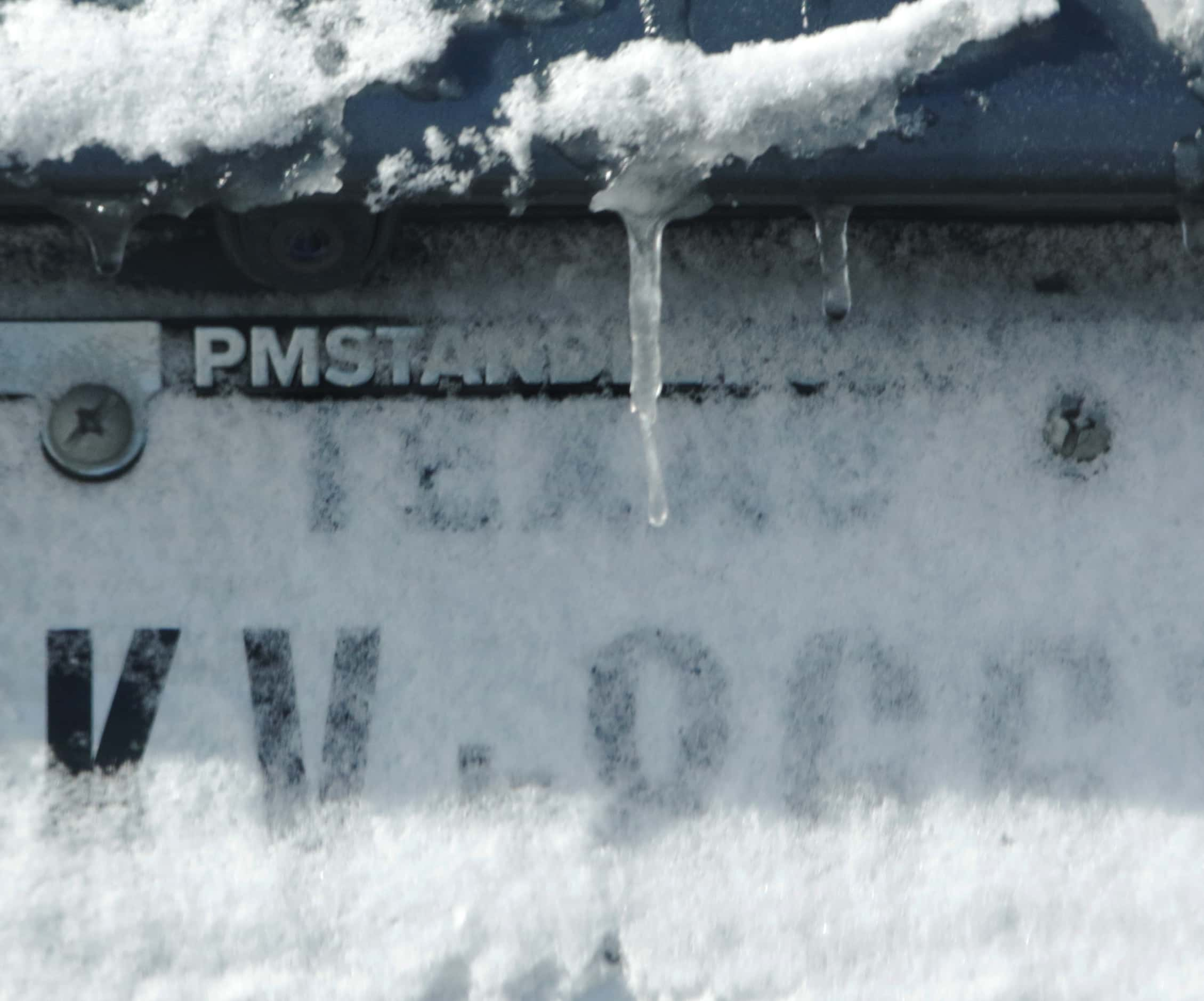 A Texas license plate is covered in snow and icicles on East Round Grove Road on January...