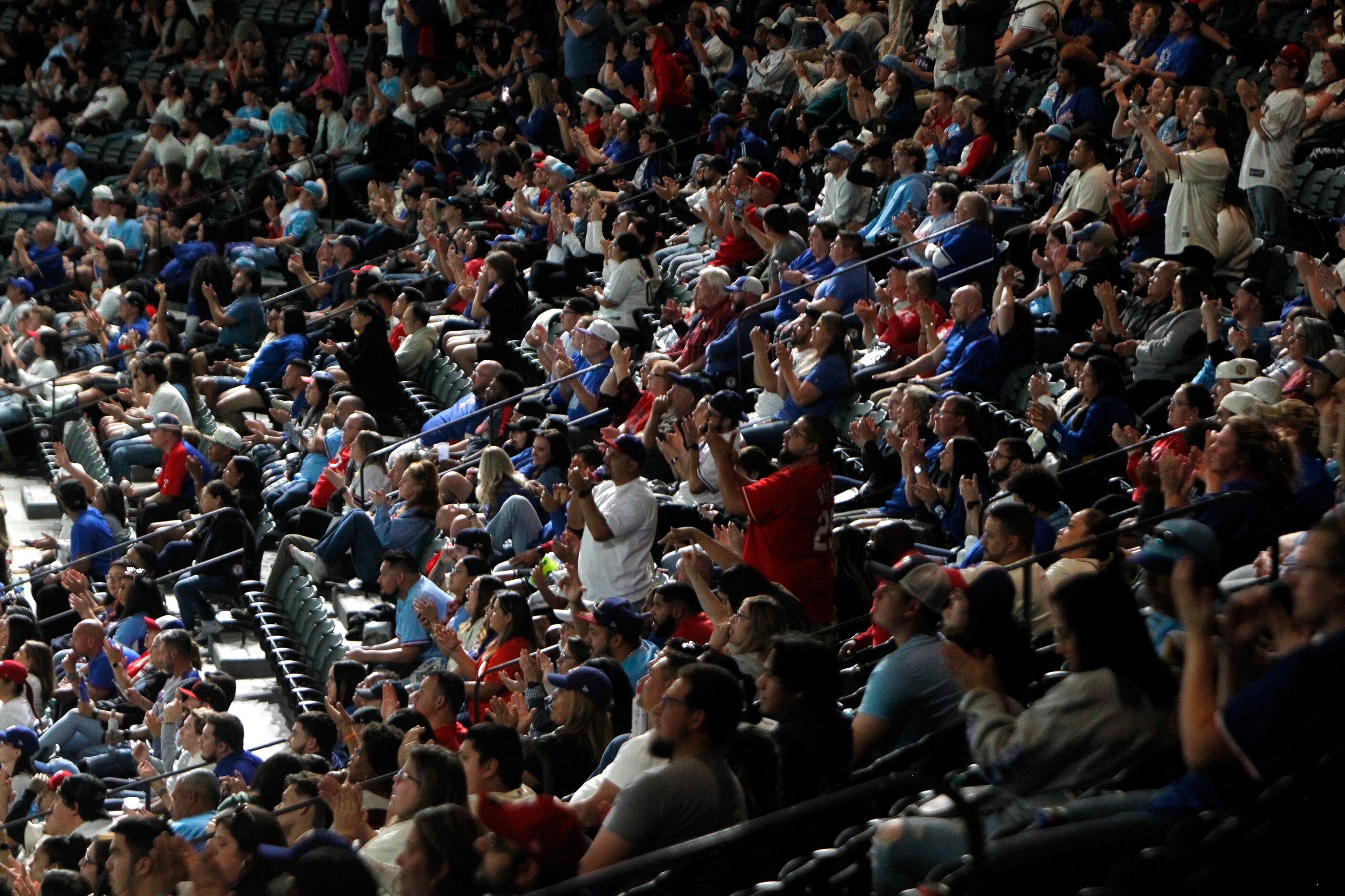 Texas Rangers fans cheer their team during Game 1 of their playoff series against the Astros...