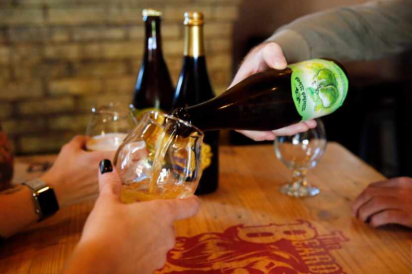 Beer lovers at the Bearded Lady  in Fort Worth share a bomber, a large-format bottle of...