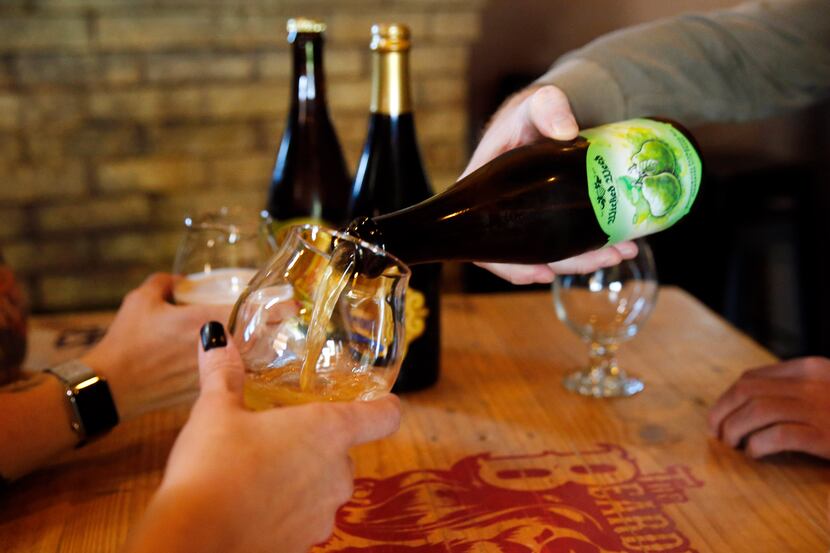 Beer lovers at the Bearded Lady  in Fort Worth share a bomber, a large-format bottle of...