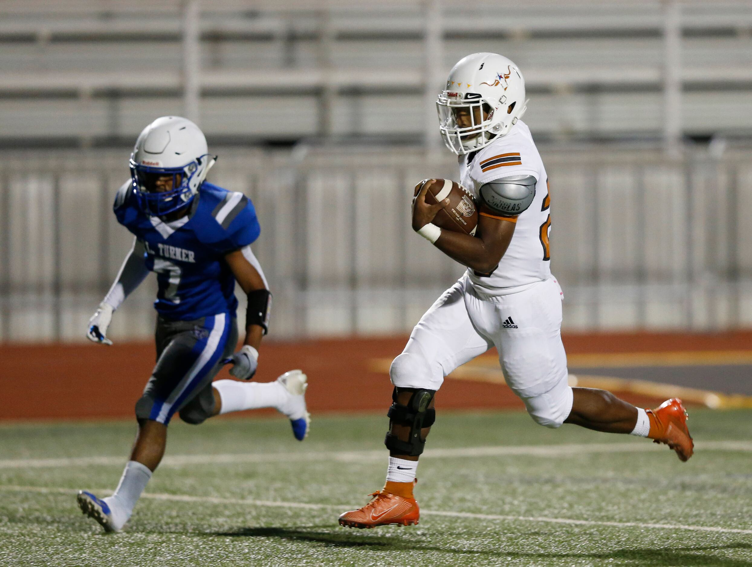 W.T. White's Elijah Edwards (20) runs for a touchdown in front of Carrollton R.L. Turner's...