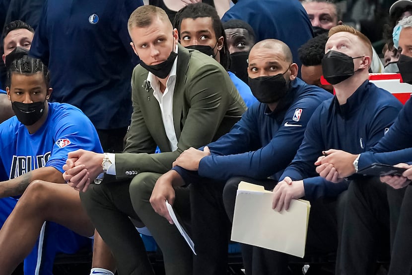 Dallas Mavericks center Kristaps Porzingis watches from the bench during the second half of...