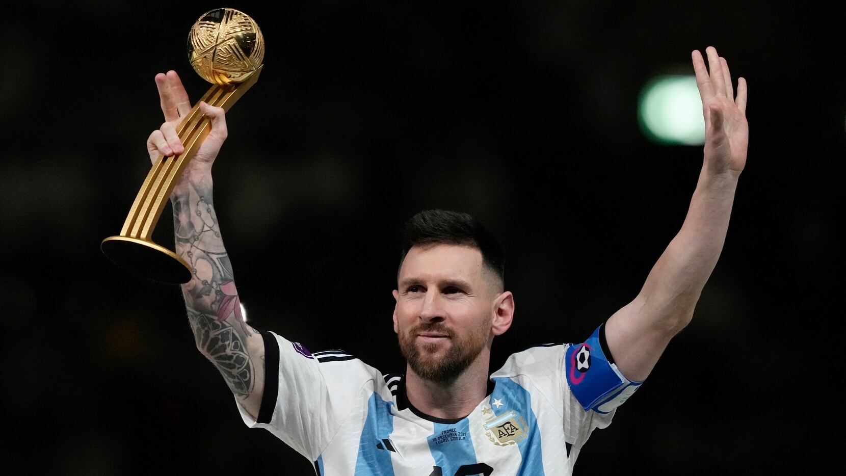 Argentina's Lionel Messi waves after receiving the Golden Ball award for best player of the...